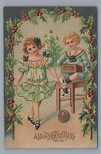 A Merry CHRISTMAS Children Boy and Girl with Ball, Tree Vintage 1907 Postcard picture