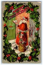 c1910's A Happy Christmas Holly Santa Claus Delivering Toys Embossed Postcard picture