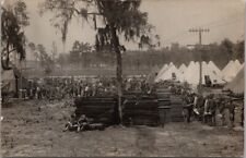 Vintage 1910s WWI Military RPPC Photo Postcard Soldiers / Tents / Stack of Cots picture