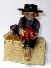 Vintage Cast Metal Amish Boy Holding Pig  Coin Bank 5” picture