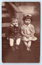 Adorable Boy and Girl Seated Studio Portrait Fashion RPPC Postcard c.1929 picture