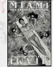 1980 Press Photo Miami advertising poster featuring people enjoying a pool picture